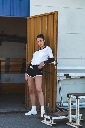 Relaxed sportswoman near gym door