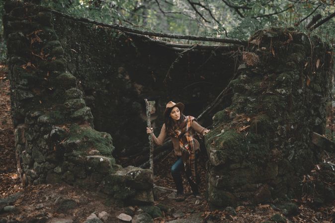 Unrecognizable hiker in green forest