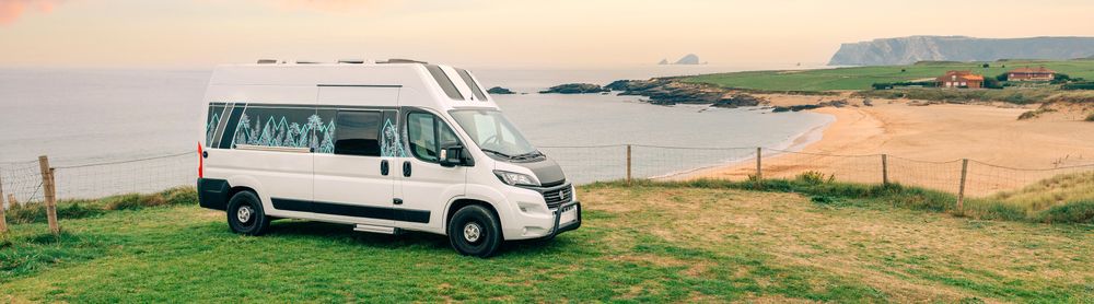 Motorhome parked above beautiful view of the coast