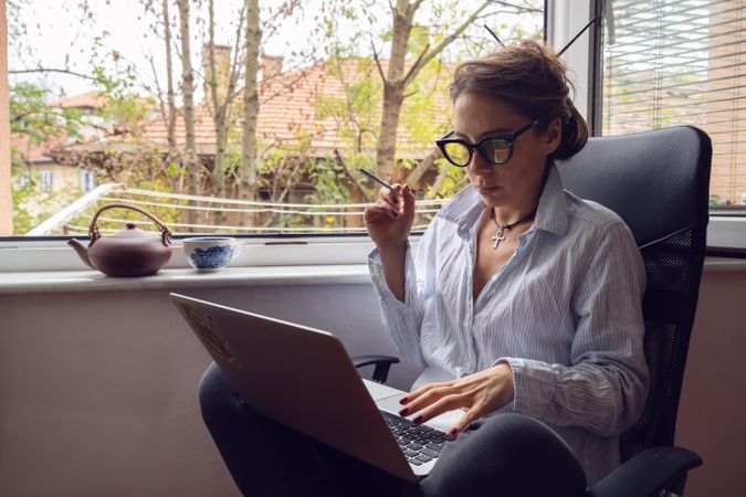 Woman with laptop smoking