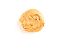 Creamy peanut butter isolated on bright background, top view. A traditional product of American cuisine