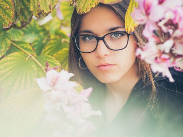 Portrait of woman among blooming trees