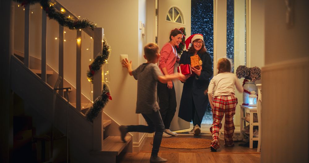 Grandmother Visiting Family for Christmas Holidays on a Snowy Winter Evening.