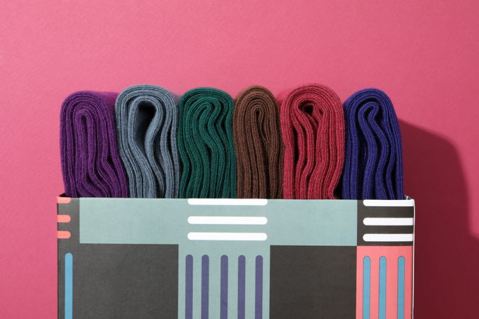 Multicolored high socks on a pink background.