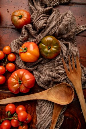 Tomatoes and napkins on wooden table