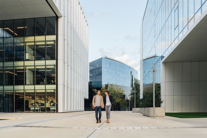 Businesspeople couple outside contemporary building