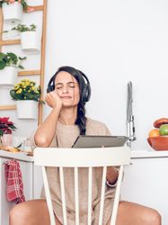 Content woman listening to music in headphones