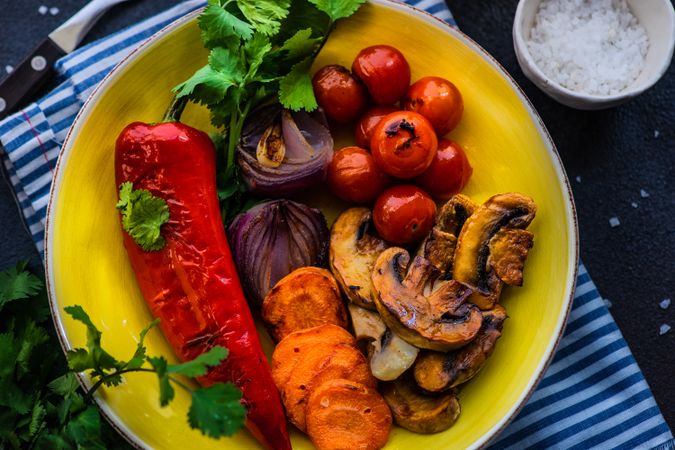 To view plate of grilled vegetable on striped blue napkin