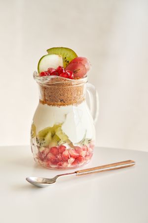 Delicious yogurt dessert with pomegranate, kiwi, grape and ginger biscuit