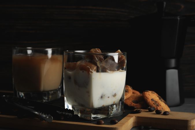 Composition with ice coffee and cookies on wooden background