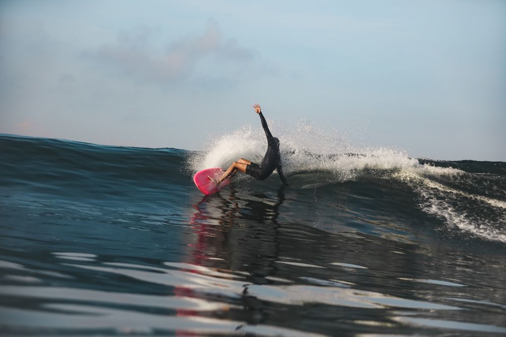 Man on surf board on waving water
