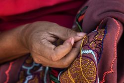 Person making traditional native San  Francisco Community embroidery in Pucallpa, Peru