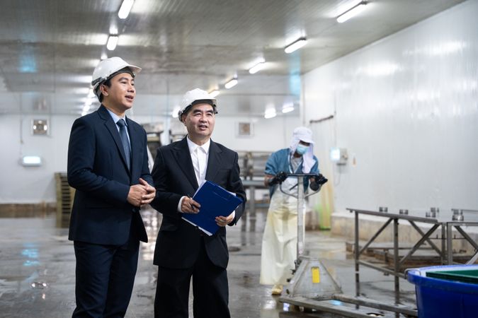 Entrepreneur inspecting at food processing in manufacturing line production.