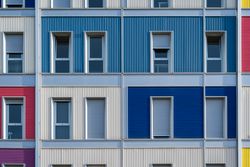 Facade of modern multicolored building with narrow windows