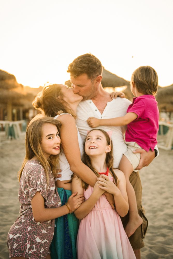 Beautiful happy family with children on beach