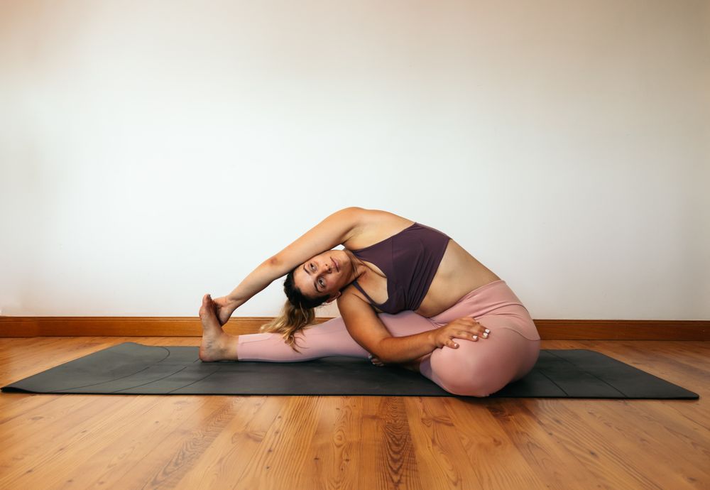 Woman in sportswear doing yoga at home