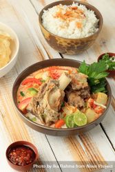 Bowl of Indonesian beef stew served on the bone with rice bevjE0