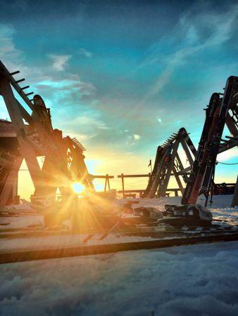 Heavy machines covered with snow at sunset