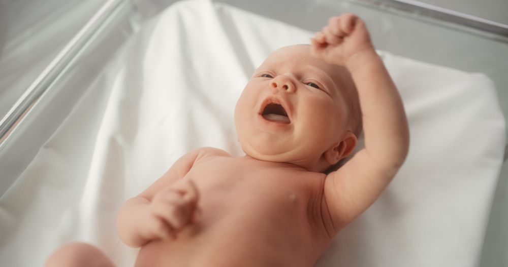 Adorable Newborn Child Lying in Hospital Bed in a Nursery Clinic.