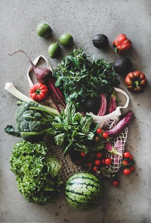 Fresh produce, top view, vertical composition with mesh bag with red peppers