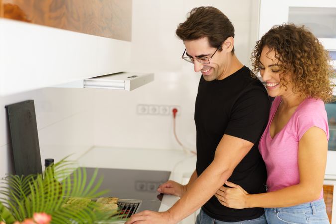 Loving couple standing in kitchen together