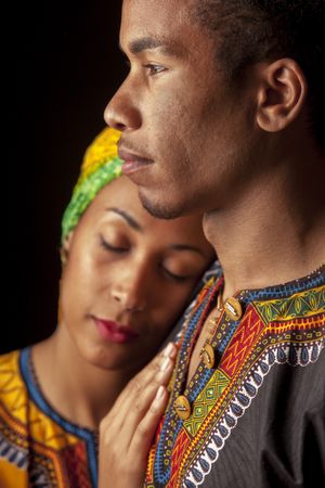 Woman with eyes closed clinging to ethnic man