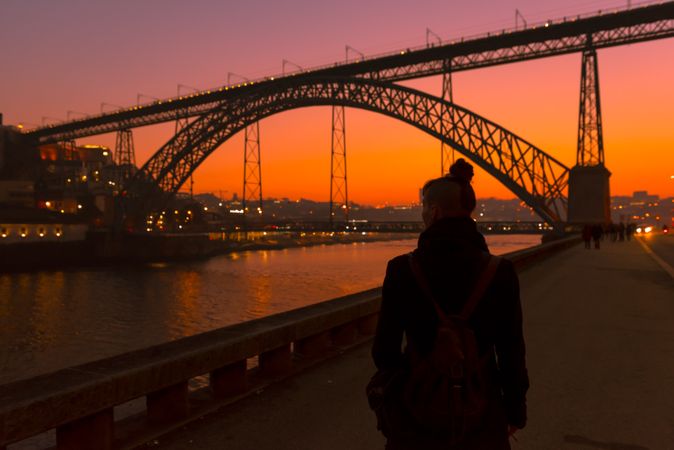 Female walking on embankment during sundown