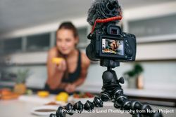 Camera viewfinder showing woman with lemon in hand 56wQN4