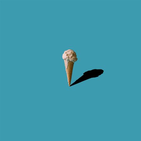 Ice cream and shadow on blue background