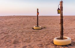 Poles with lanterns in desert