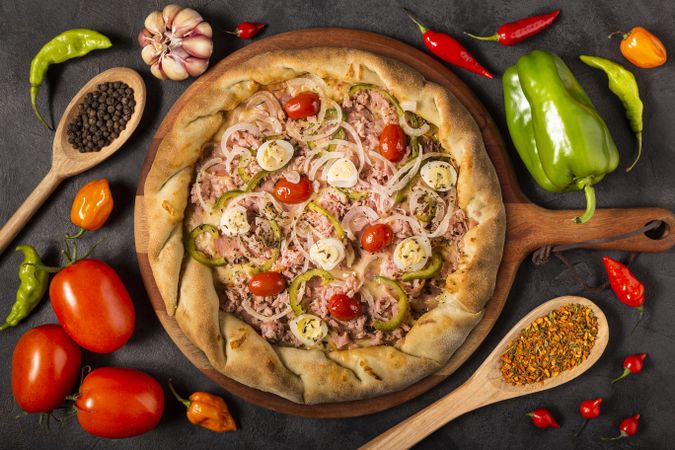 Empty pizza  board on the table with Ingredients for cooking