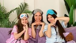 Mother and daughters in sleepwear enjoying home day together.