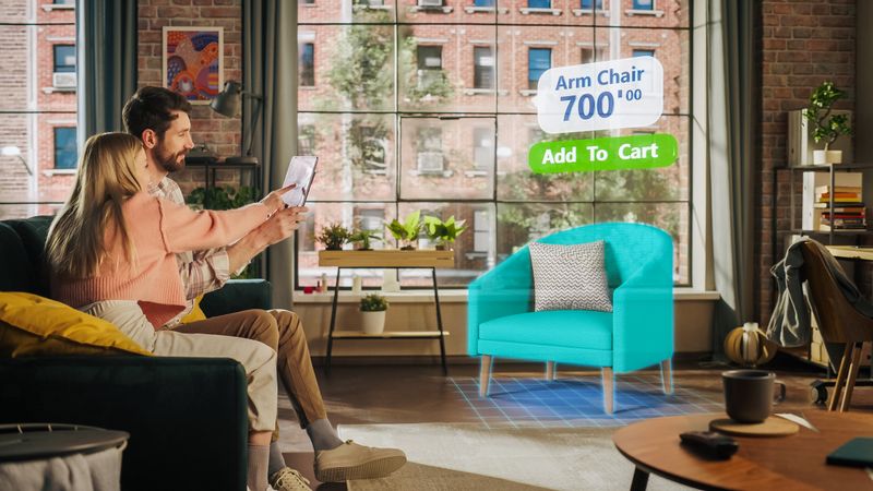 Decorating Apartment: Couple Holding Digital Tablet Computer, using Augmented Reality Interior Design Software Chooses 3D Furniture for Home.