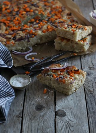 Pieces of fresh focaccia on wooden table