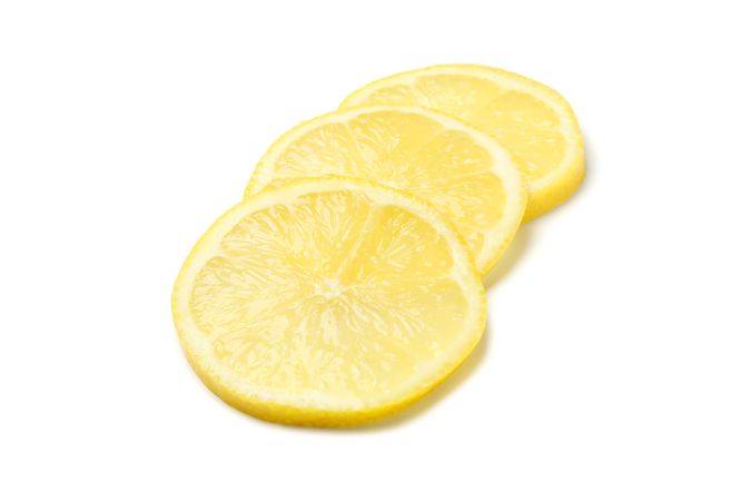 Lemons slices isolated on light background. Ripe fruit