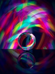 Crystal ball on board near abstract shines