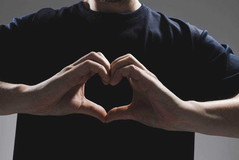 Man forming heart with hands