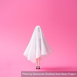 Doll under ghost sheet costume against pastel pink background 4BRde4