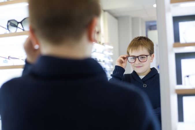 Young boy trying on glasses