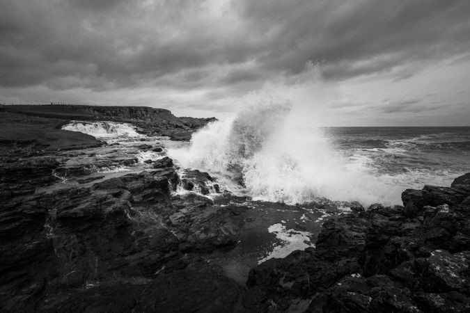 Waves breaking on shore on stormy day