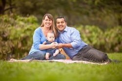 Happy  Family Having a Picnic and Playing In The Park