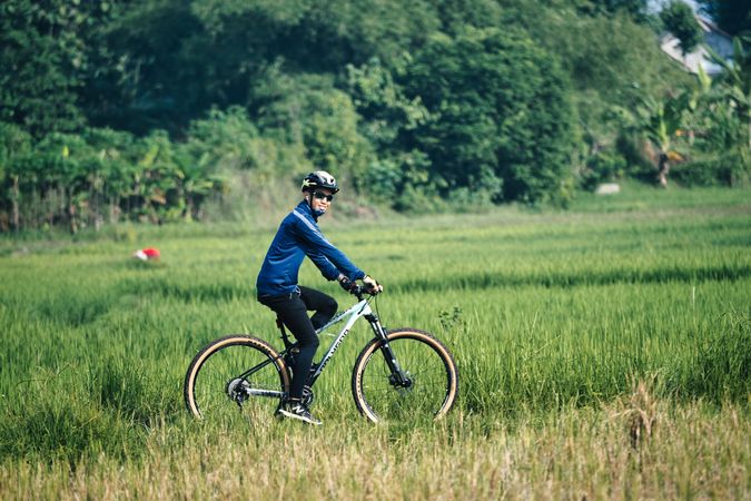 Man riding a bicycle on green grass