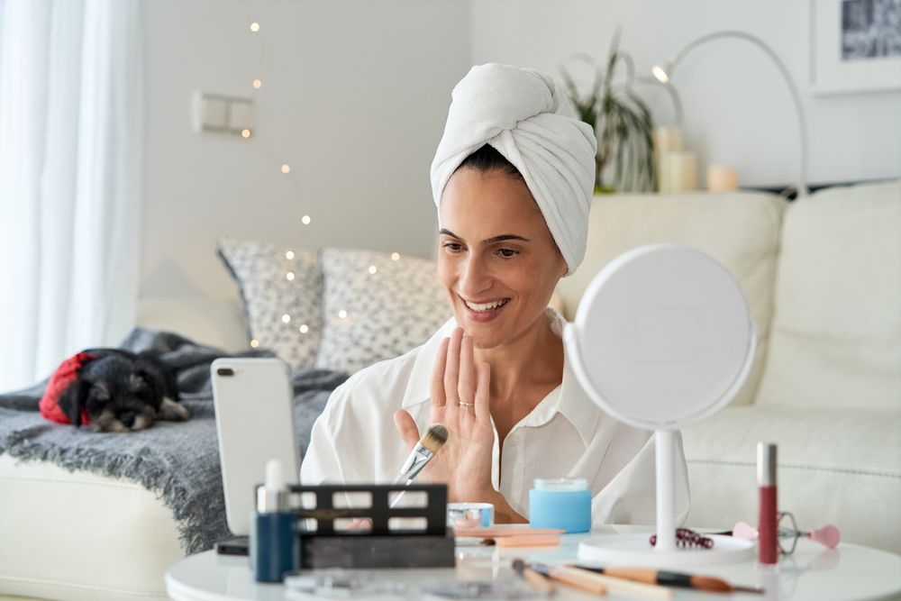 Cheerful woman recording beauty routine tutorial