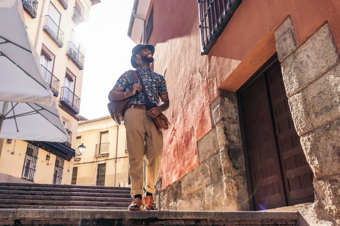 Stylish Black man walking on the city street