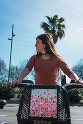 Young woman riding back on scooter