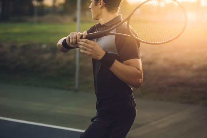 Tennis player playing on club hard court