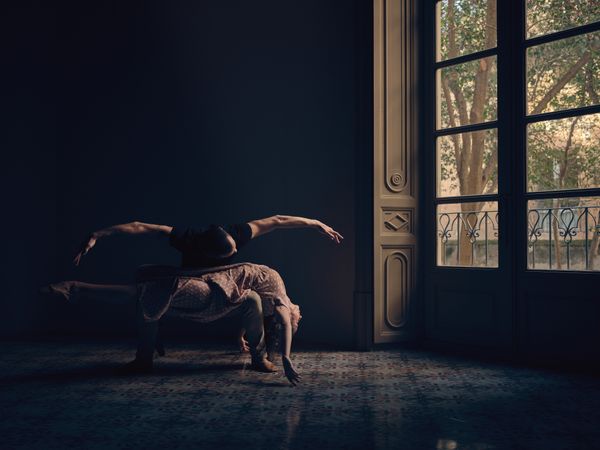 Couple dancing ballet in obscure room