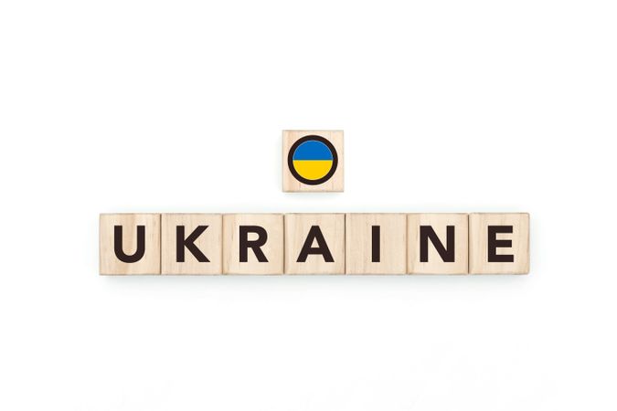 Wooden blocks bearing the name and flag of Ukraine. Ukrainian and East European Culture, national identity, travel, and geography in a copy space design.
