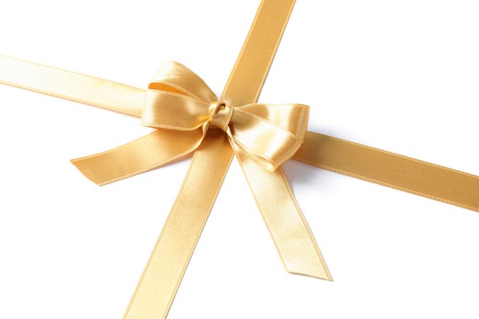 Golden ribbon with bow isolated on plain background. Gift concept