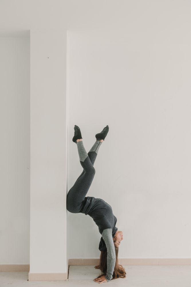 Flexible female training upside down in studio